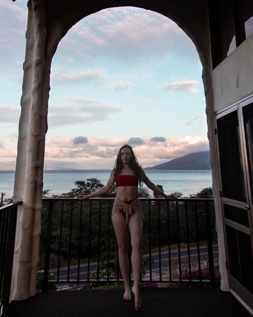 Poses For Travel Photos: Leaning against a balcony railing in Maui, Hawaii