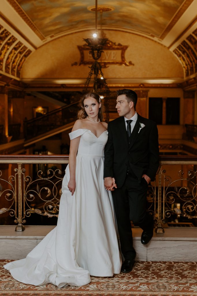 Wedding portrait of bride and groom in the Pfister Hotel lobby ceiling